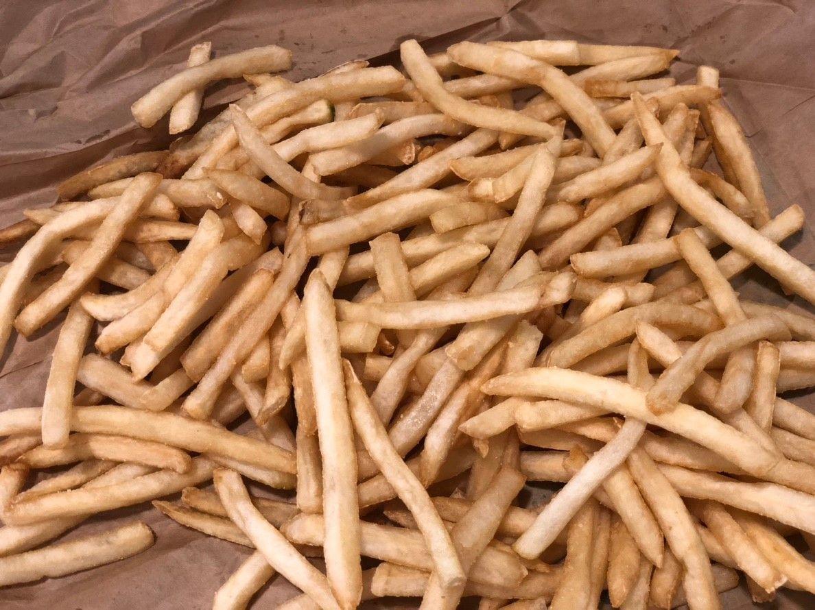 Heap of McDonald's French fries laid out on brown paper, part of McDonald's Korea menu.